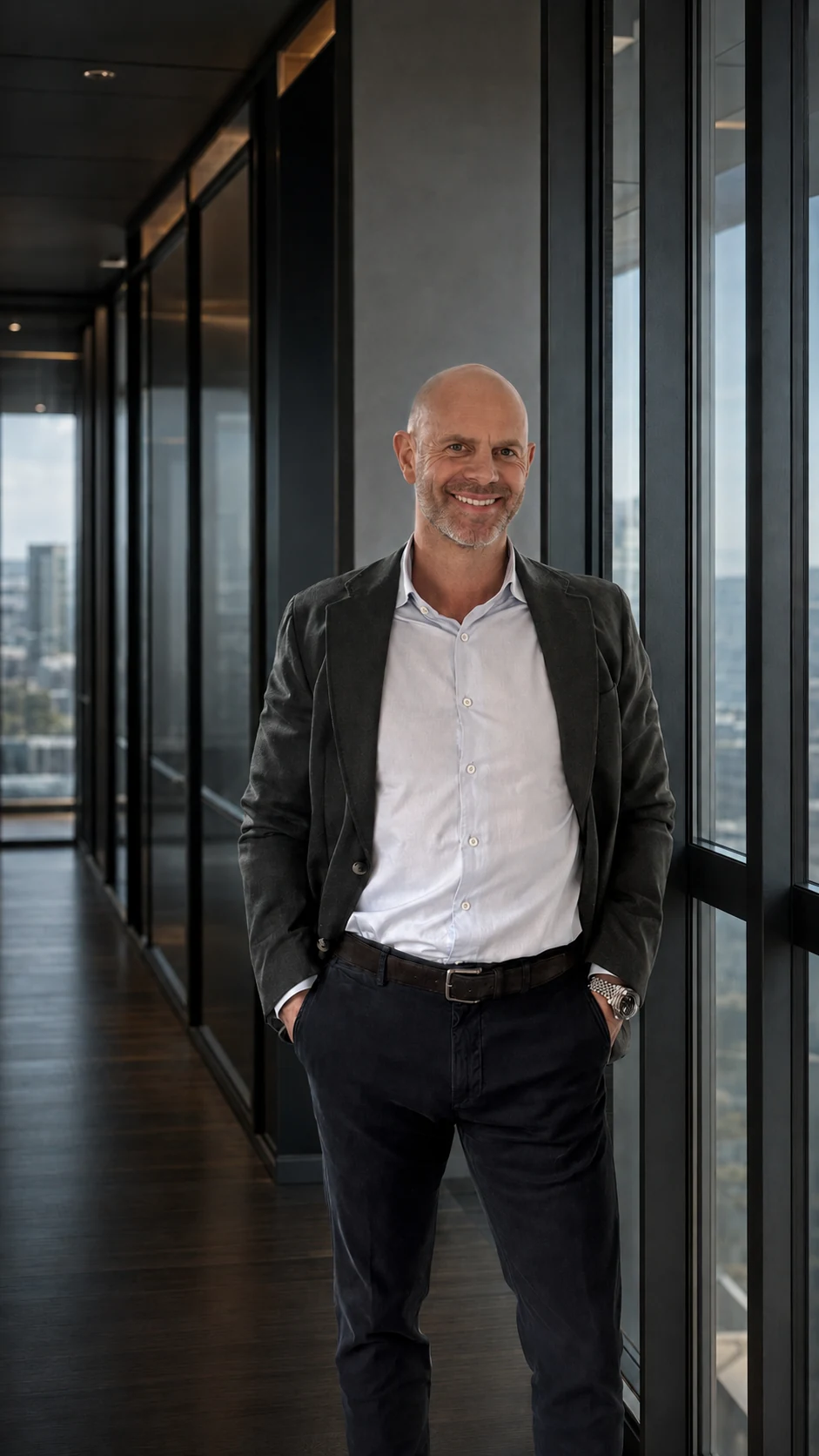 Bevan Gray standing in a contemporary glass office