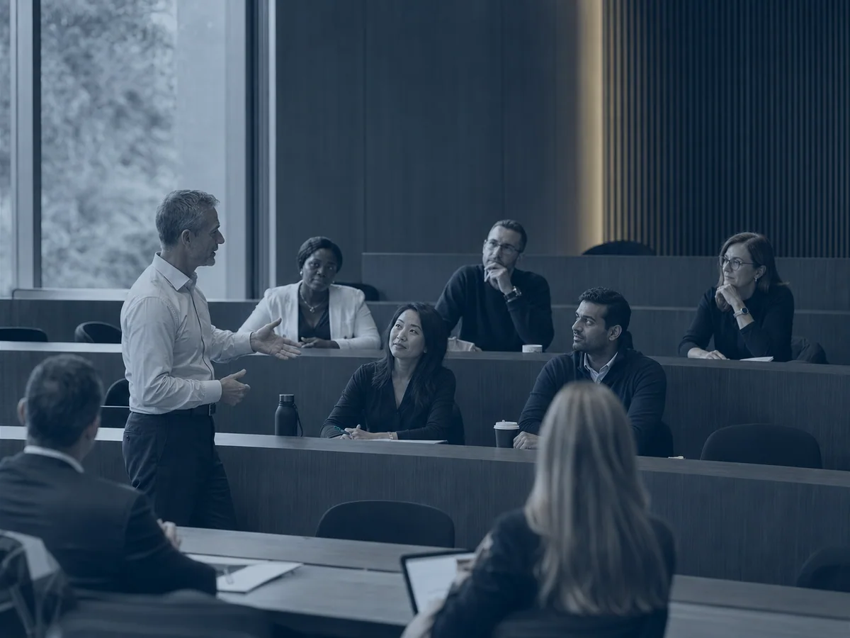 Executive faculty leading a business school session
